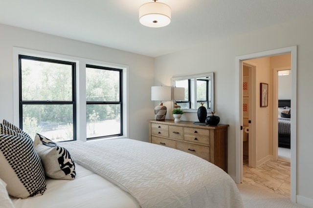 bedroom with light colored carpet and multiple windows