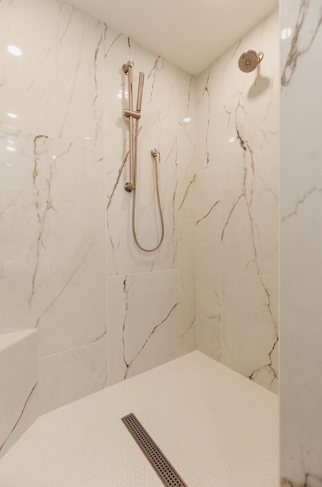 bathroom with a tile shower