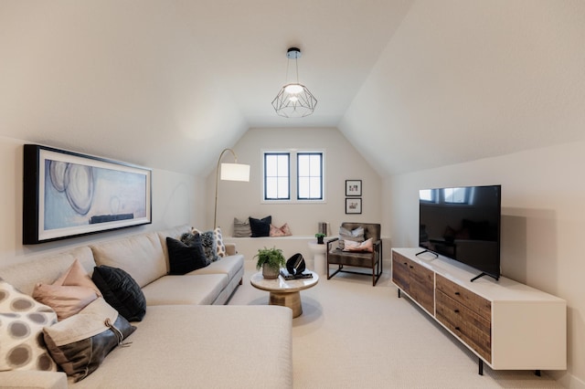 carpeted living room featuring vaulted ceiling