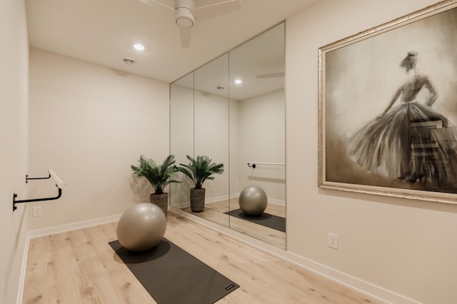 exercise room featuring light hardwood / wood-style flooring and ceiling fan