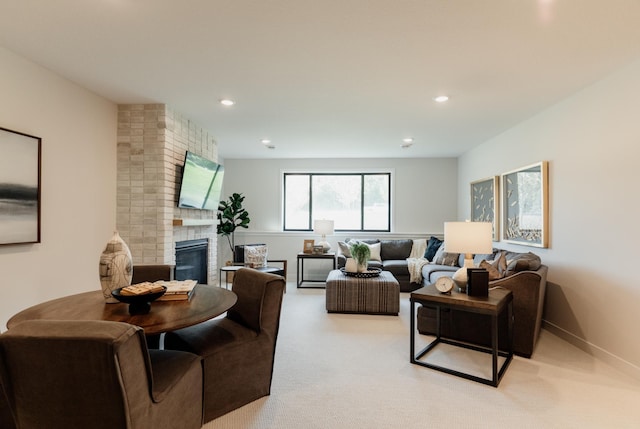 carpeted living room with a brick fireplace