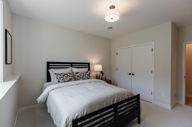 bedroom with light carpet and a closet