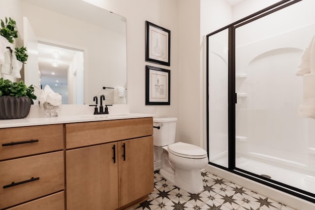 bathroom featuring vanity, toilet, and walk in shower