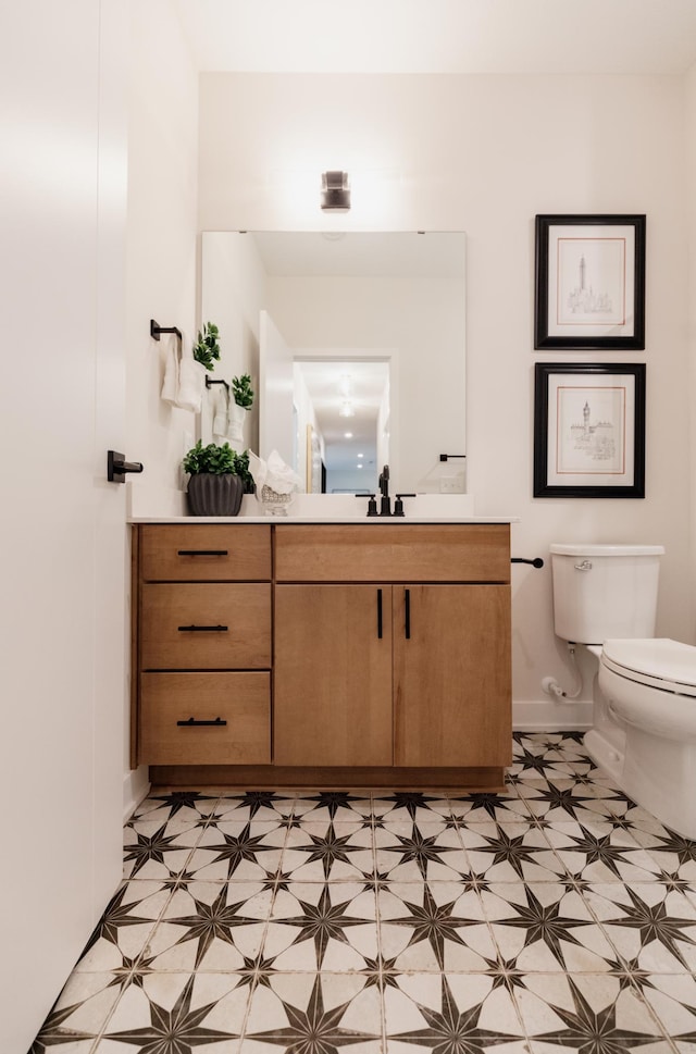 bathroom featuring vanity and toilet