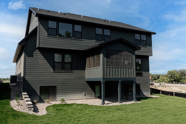 rear view of house featuring a yard