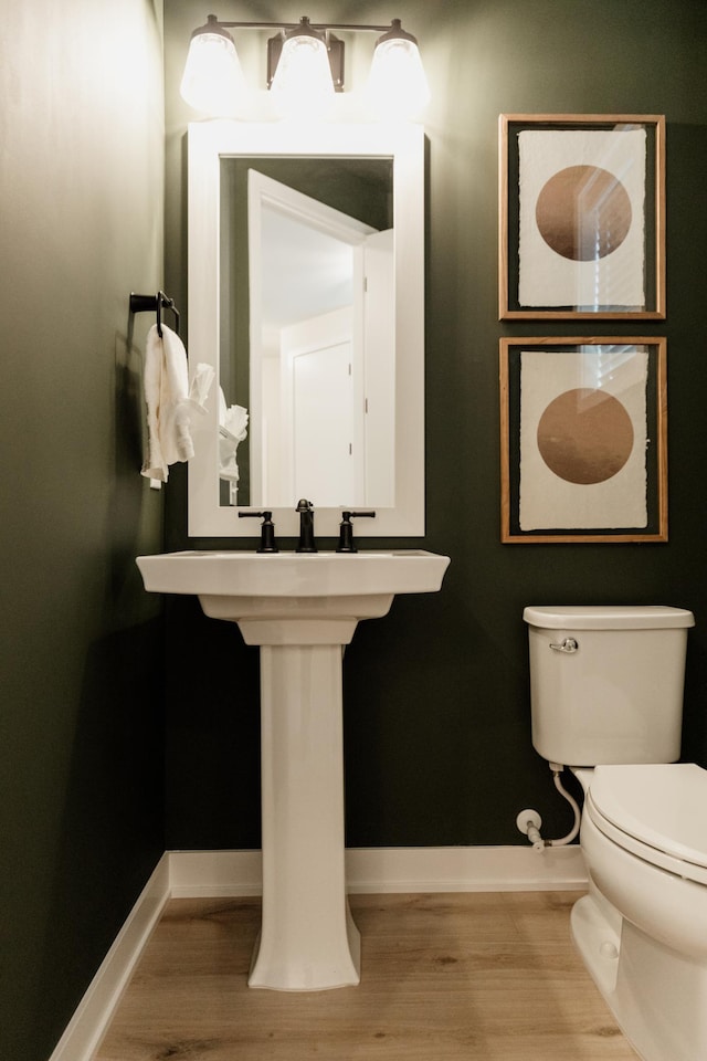 bathroom featuring hardwood / wood-style floors and toilet