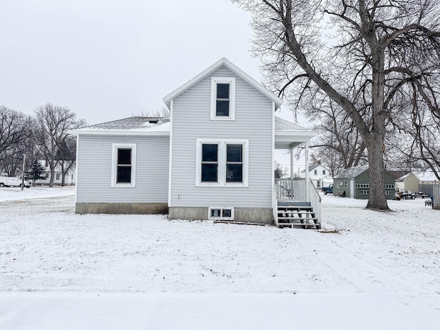 view of snow covered rear of property