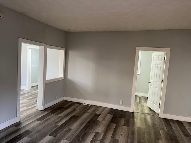 unfurnished room featuring dark hardwood / wood-style floors