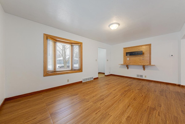 unfurnished living room featuring light hardwood / wood-style floors