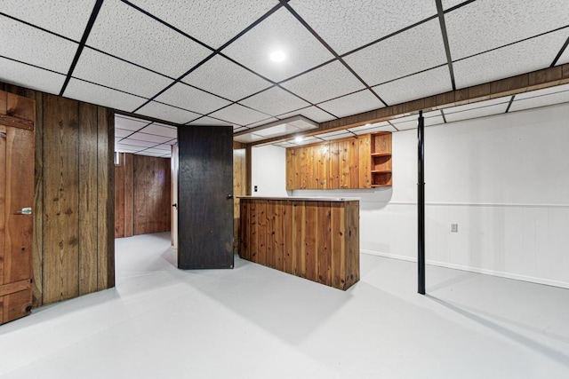 basement featuring wooden walls