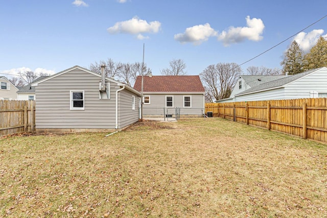 rear view of house with a lawn