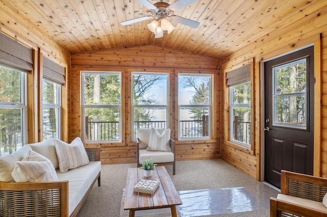 sunroom featuring plenty of natural light, wooden ceiling, a ceiling fan, and lofted ceiling