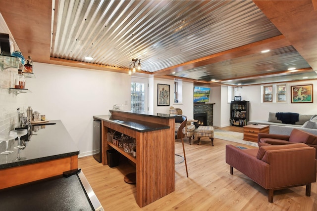 bar with wooden ceiling and light hardwood / wood-style floors