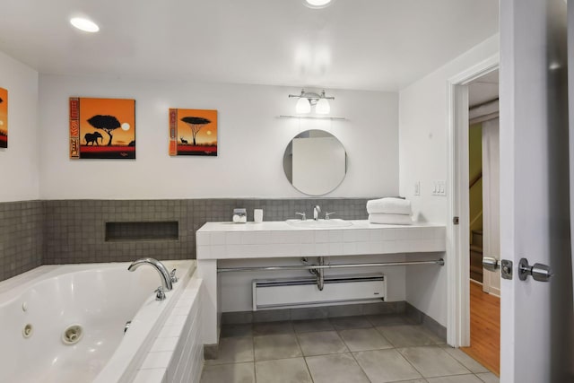 bathroom with vanity, a baseboard radiator, tile patterned floors, and tiled bath