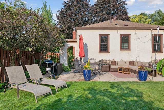 rear view of property with a yard, a patio area, and outdoor lounge area