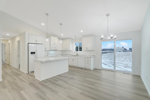 kitchen featuring a kitchen island, white appliances, white cabinetry, and pendant lighting