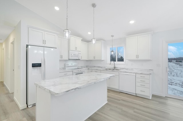 kitchen with white appliances, a kitchen island, white cabinetry, and sink