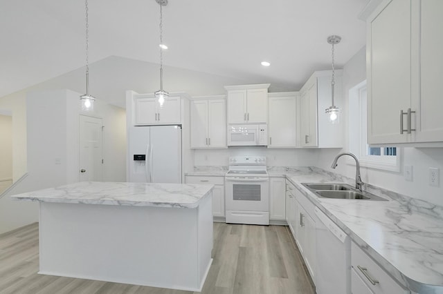 kitchen with white appliances, sink, and a center island