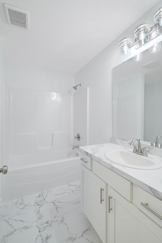 bathroom with bathing tub / shower combination and vanity