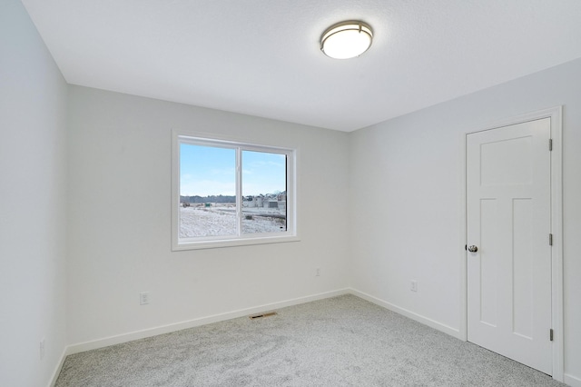 unfurnished room with light colored carpet