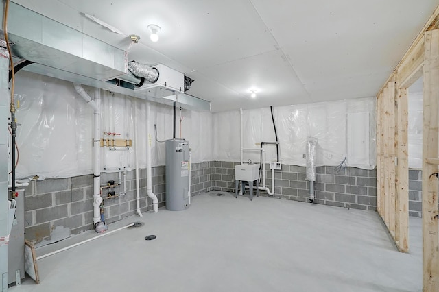 basement featuring sink and water heater