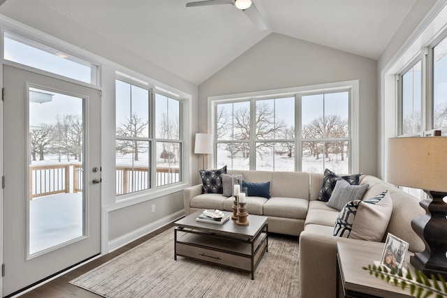 sunroom with plenty of natural light, ceiling fan, and vaulted ceiling