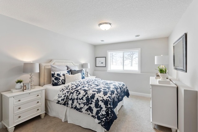 carpeted bedroom featuring a textured ceiling