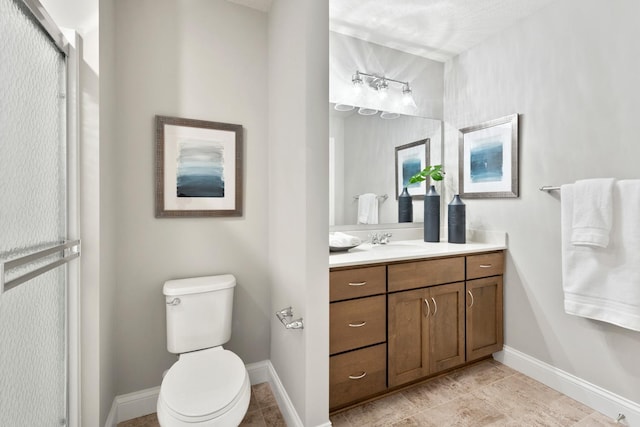 bathroom with vanity, an enclosed shower, and toilet