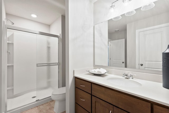 bathroom with vanity, toilet, and walk in shower