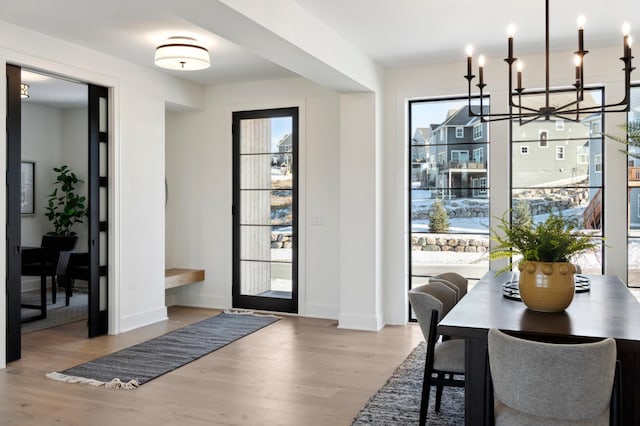 interior space featuring light wood-type flooring and a notable chandelier