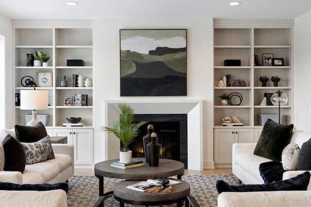 living room with light hardwood / wood-style floors and built in features