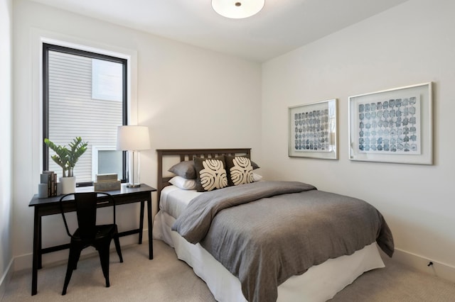 carpeted bedroom featuring multiple windows