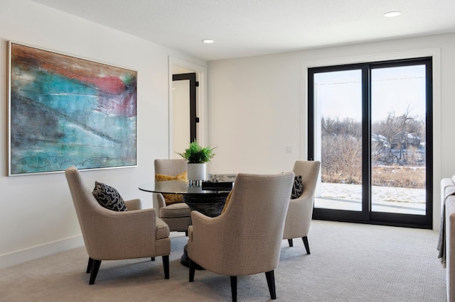 dining space featuring light colored carpet