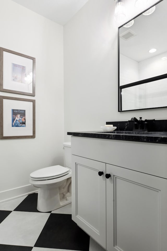 bathroom featuring vanity, toilet, and a shower with door