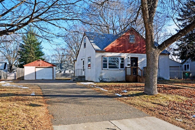 view of front facade featuring a garage and an outdoor structure