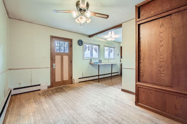 interior space with beamed ceiling, ceiling fan, light wood-type flooring, and baseboard heating