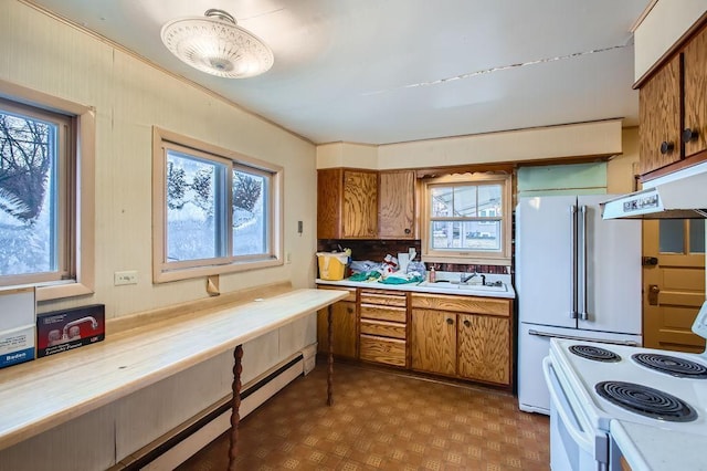 kitchen featuring white appliances, sink, and a baseboard heating unit