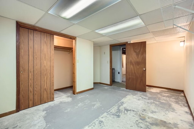 unfurnished bedroom with a paneled ceiling and a closet