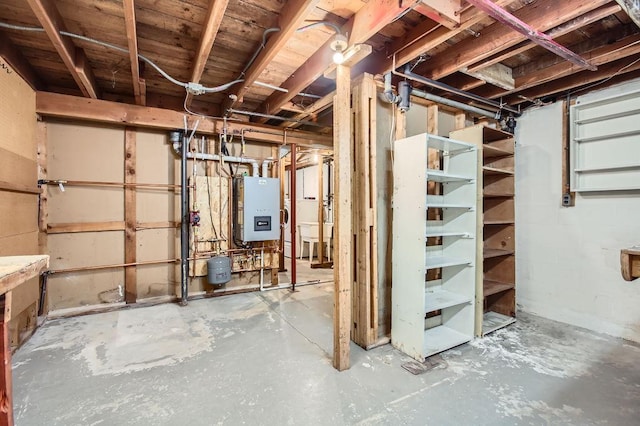 basement featuring sink and water heater