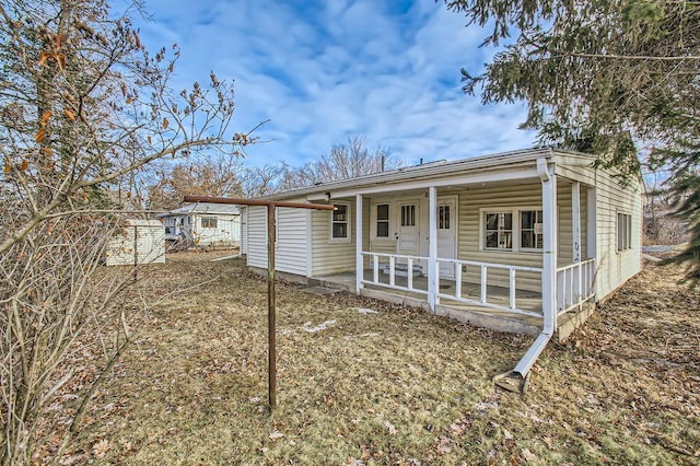 rear view of property with covered porch