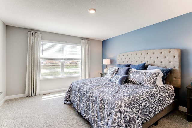 carpeted bedroom featuring a textured ceiling