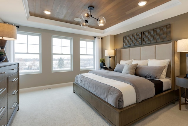 carpeted bedroom with a raised ceiling, wood ceiling, and an inviting chandelier