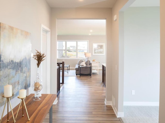 hall with hardwood / wood-style flooring