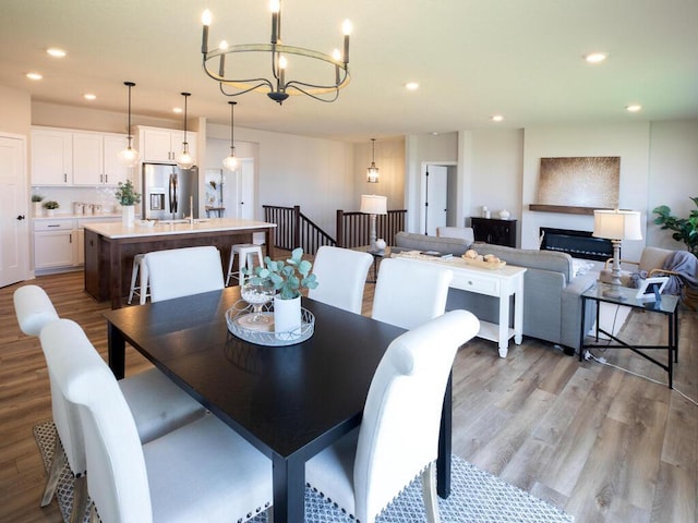 dining room with a notable chandelier and light hardwood / wood-style floors