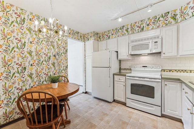 kitchen with white cabinets, decorative backsplash, white appliances, and track lighting