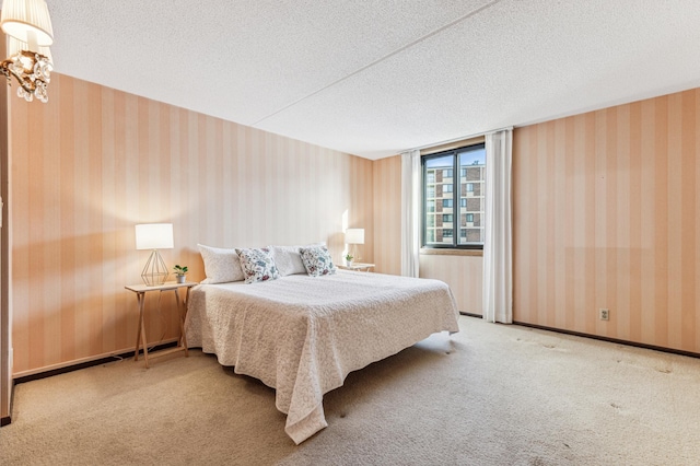 bedroom featuring a textured ceiling and carpet floors