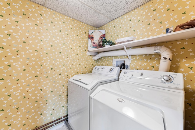 clothes washing area with washing machine and dryer