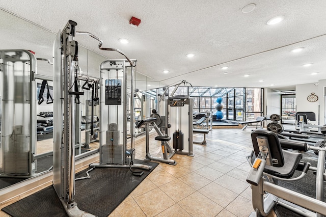 workout area with a textured ceiling and light tile patterned flooring