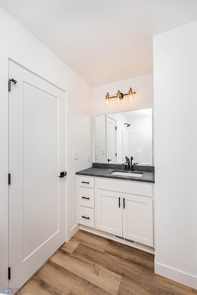 bathroom featuring hardwood / wood-style floors and vanity