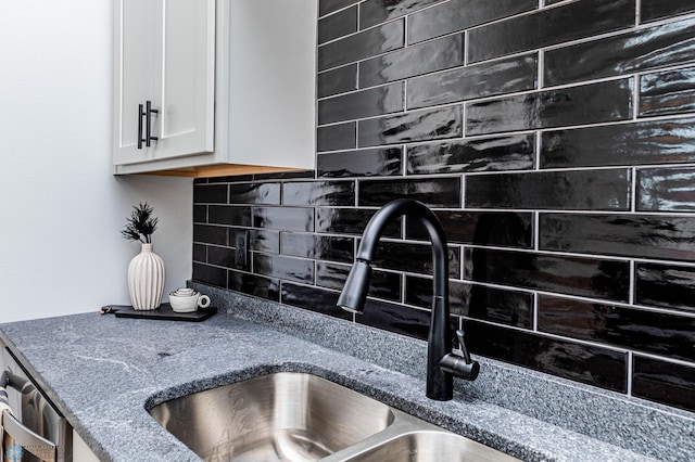 129 Pine Ave, Mapleton, ND 58059 - kitchen view of decorative backsplash, white cabinets, a sink, and stone counters